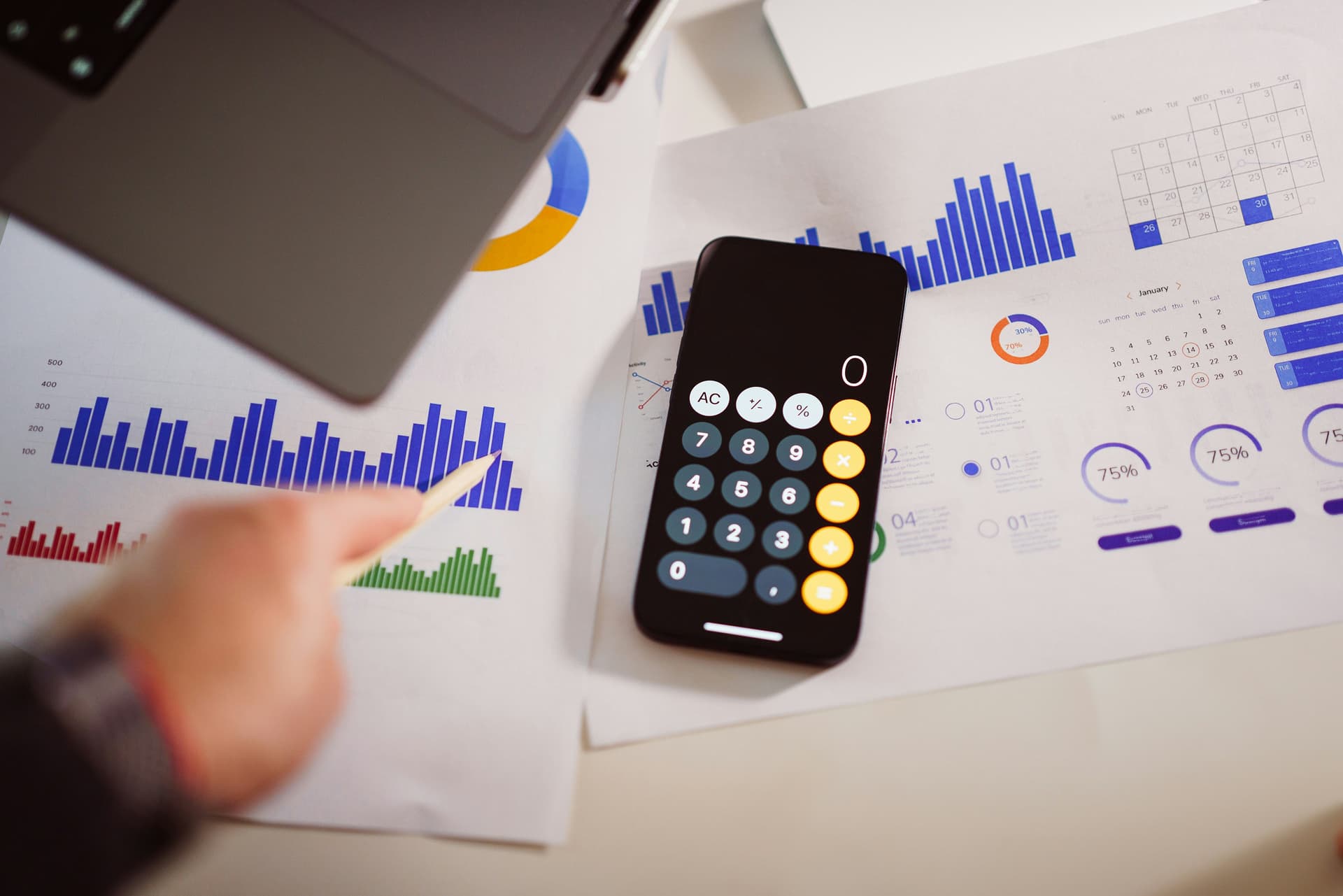Calculator, tax forms and crypto coins representing cryptocurrency tax calculations