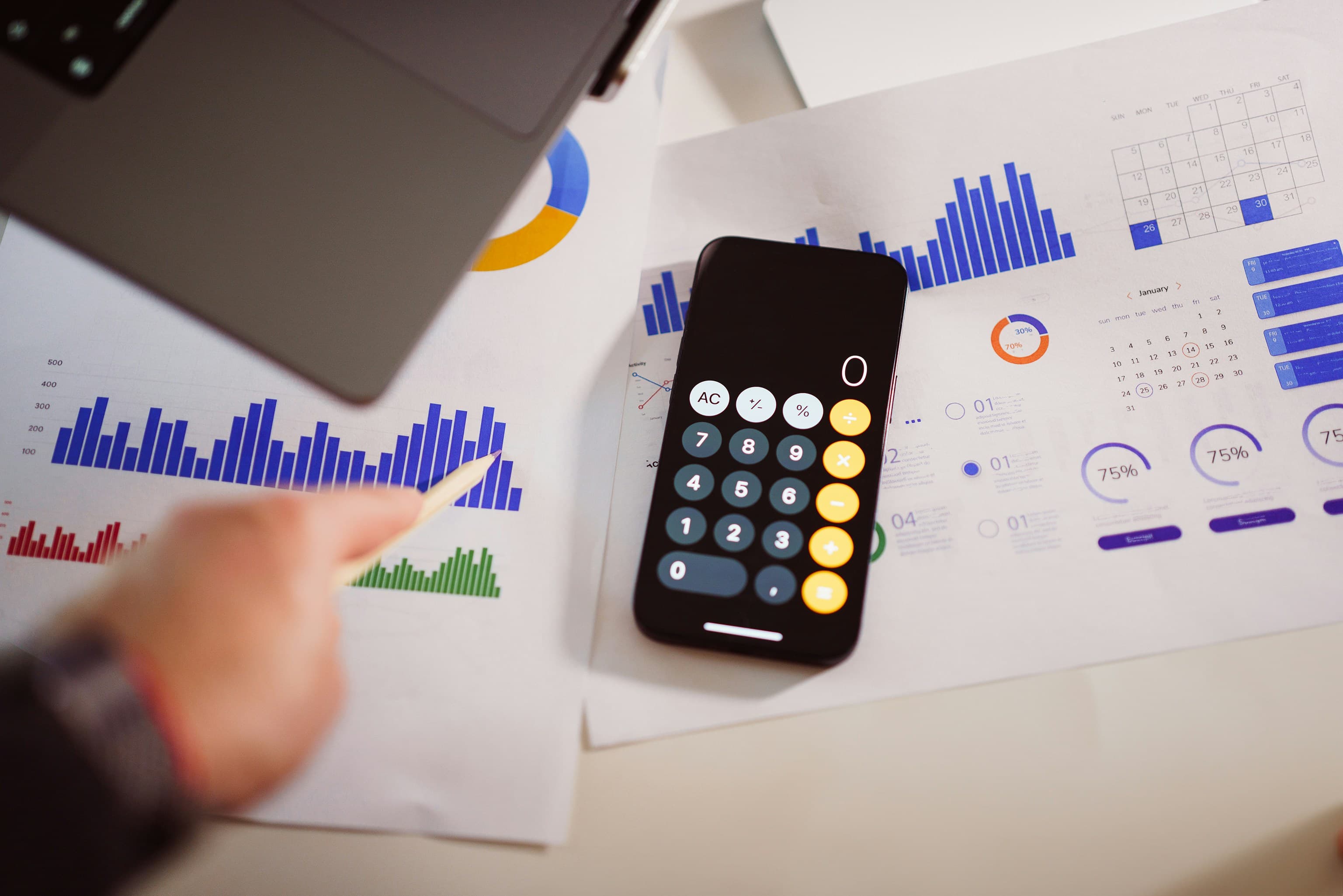 Calculator, tax forms and crypto coins representing cryptocurrency tax calculations